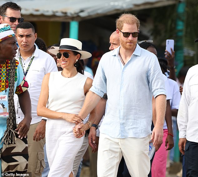 Meghan wore a white linen skirt, sleeveless blouse and Panama hat, while Harry wore a blue linen shirt