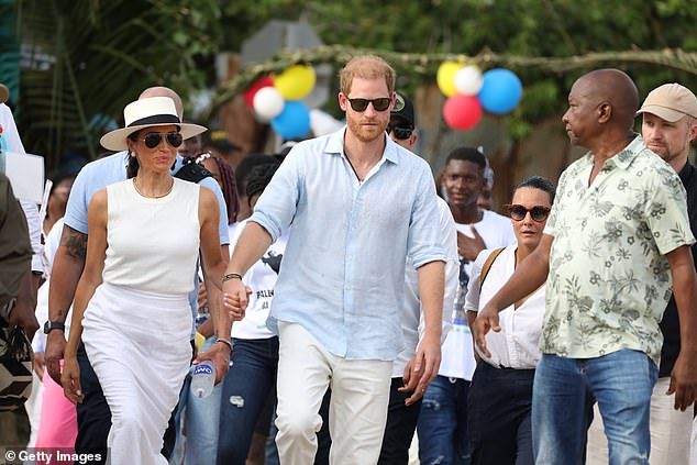 The couple were surrounded by people as they walked through the streets of San Basilio de Palenque