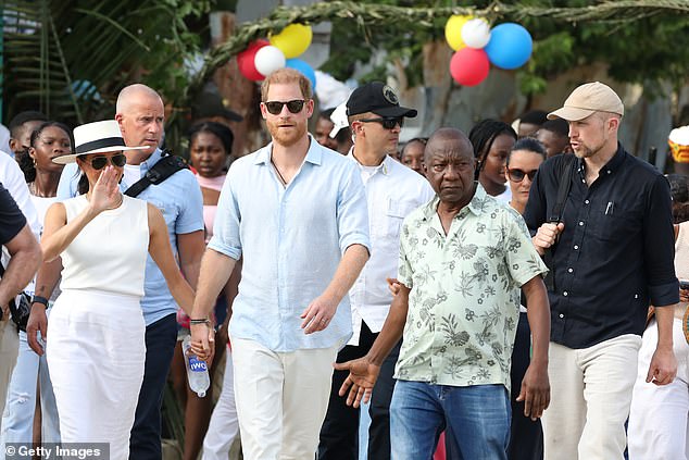 Meghan and Harry were escorted by security as they walked through the streets