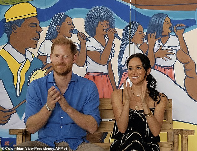 Harry and Meghan clap during a performance at La Boquilla drum school in Cartagena