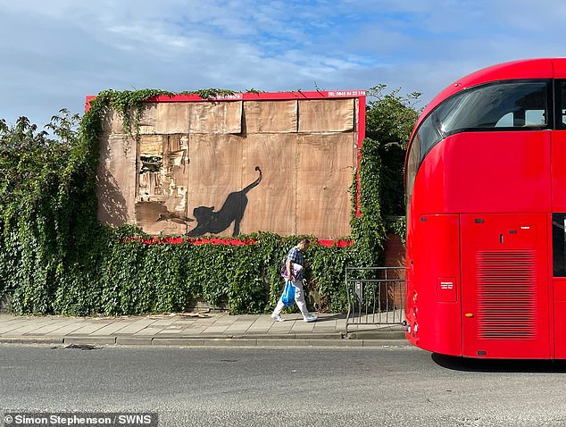 A week ago, a large silhouette of a cat was spray-painted onto an abandoned billboard in Cricklewood, showing the animal stretching and scratching at a broken piece of wood