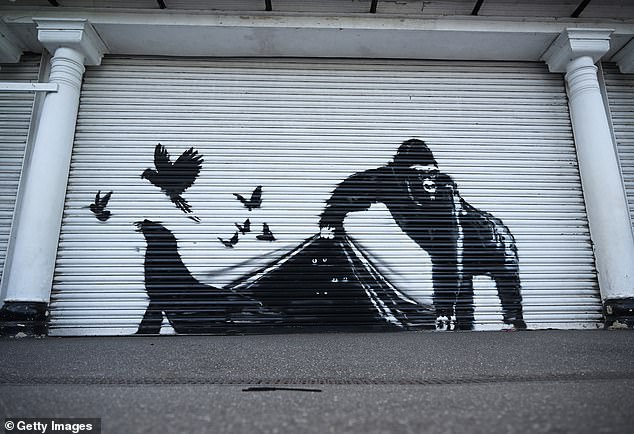 Banksy's most recent mural was painted on a white shutter at London Zoo and shows a gorilla lifting the bottom to release birds and a seal.