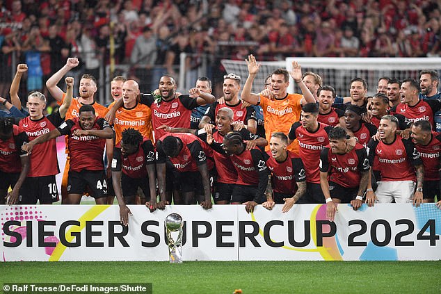 Leverkusen players pose for a team photo after winning the German Super Cup