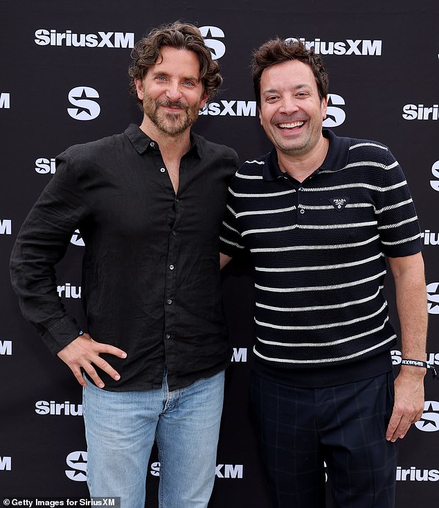 Bradley wore a black button-up shirt and light-colored jeans with gray and black Jordan sneakers; pictured with Jimmy Fallon