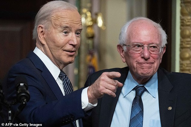 President Joe Biden gestures toward Senator Bernie Sanders, an independent from Vermont.