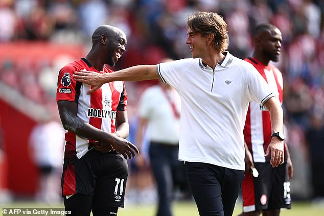 Frank pictured congratulating star player Wissa after victory in Sunday's season opener