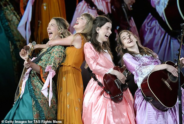 Swifities have kicked into high gear after Harry was spotted strolling around London with Taylor's close friends Este, Danielle and Alana Haim (pictured on stage with Taylor)