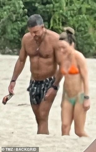 Umansky looked fit in a black and white swimsuit as he and Khan made their way to the warm waters of the Riviera Nayarit