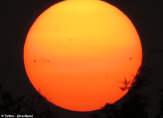 According to the Met Office, the sun could remain bright red until tonight. The sun is photographed from Merseyside