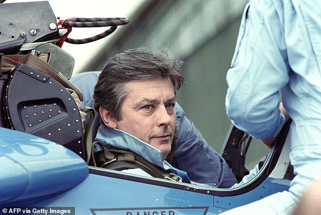 French actor Alain Delon poses aboard an Alphajet of the French Air Force Patrouille de France in Salon-de-Provence on April 18, 1988