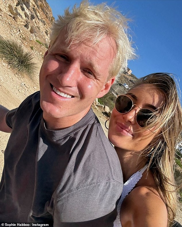 In another photo, she was spotted beaming as she cuddled up to her man as they cycled around with fellow Made In Chelsea star Jaimie looking relaxed as he smiled