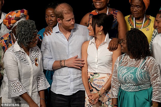 Prince Harry on stage with his wife Meghan for a group photo after her speech