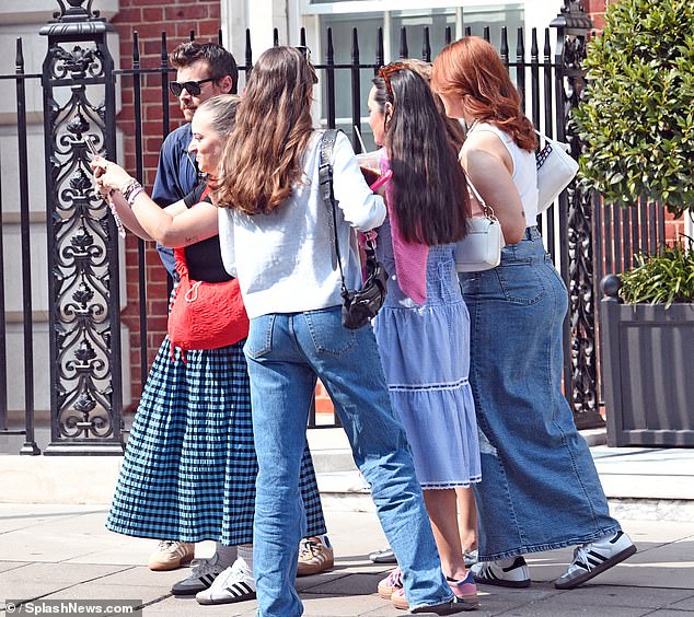 Always a gentleman, Harry stopped to take selfies with the group of girls before continuing his walk