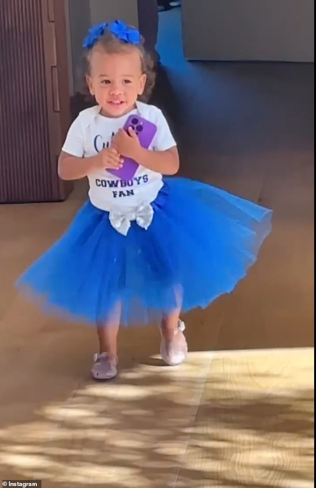 While Chrissy and Luna are applying makeup, Esti enters the room wearing a blue tutu and a white T-shirt that says 