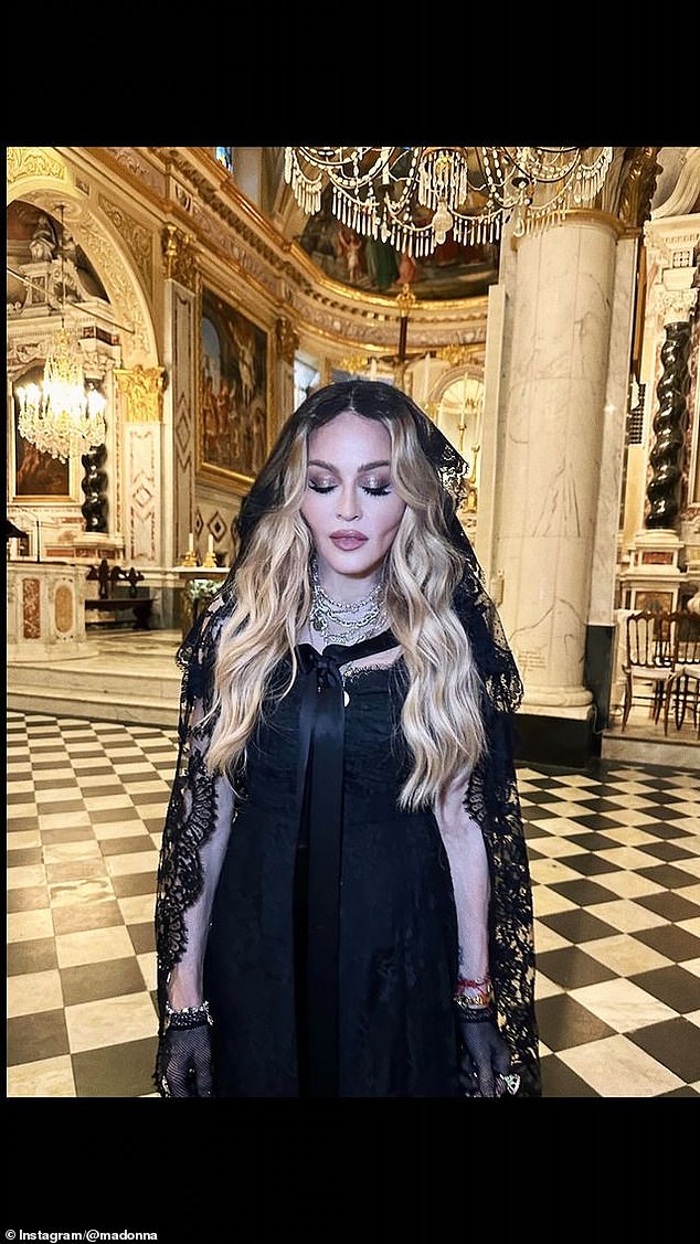 The Like A Virgin singer wore a black lace veil as she posed in what appeared to be a cathedral