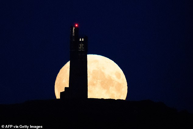 A supermoon refers to a full moon that occurs when the moon is at its closest to the Earth. In the photo, the latest full blue supermoon rises over Victoria Tower in Huddersfield