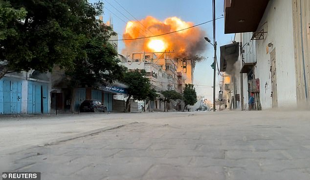 Smoke and flames rise after an Israeli attack on a residential building, amid the ongoing conflict between Israel and Hamas