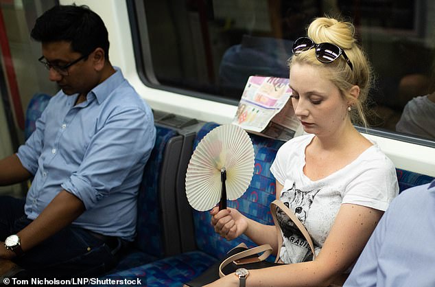 How dangerous a tube ride can be depends on both the temperature and humidity. Pictured: A woman cools down on the London Underground, July 2018