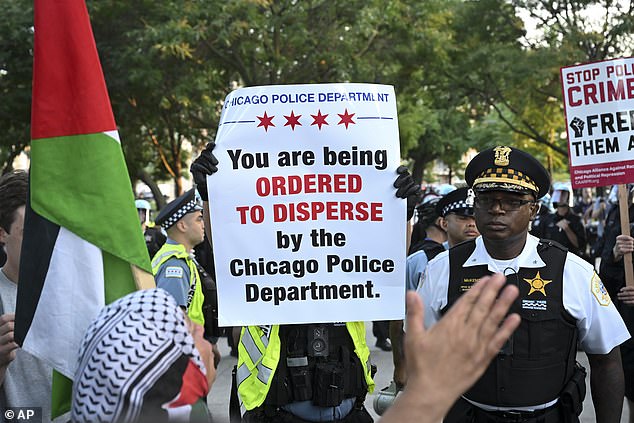 Police distribute signs telling anti-DNC protesters to disperse