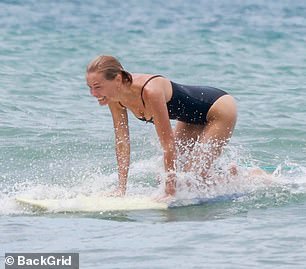 The media personality, who is married to Australian actor Sam Worthington, 48, was spotted in Costa Rica with her beau as the pair went surfing