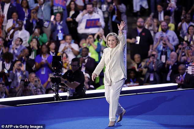 Hillary Clinton arrives onstage during Monday night's session of the Democratic National Convention in Chicago. She wore her signature suffragette white and spoke about women barrier breakers