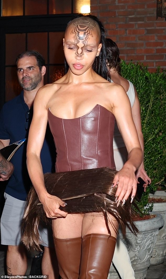 FKA twigs (born Tahliah Debrett Barnett) carried a furry clutch most likely designed by Charlie Le Mindu