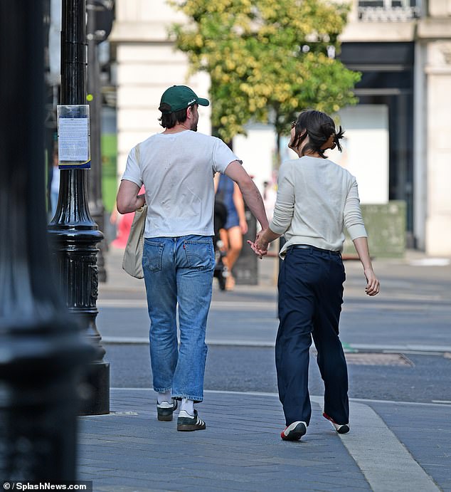 Paul also had a cream-colored bag under his arm during the outing