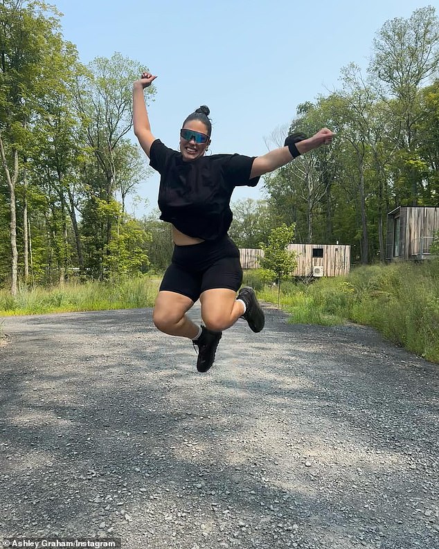 They spent a lot of time relaxing in the scenic wilderness, as seen in another photo of Graham jumping into the air for joy. Decked out in sportswear and futuristic sunglasses, she looked ready for an adventure and a hike