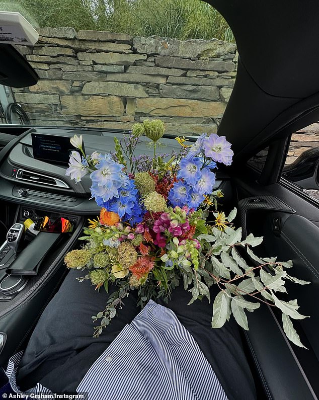 She also snapped a photo of the lavish floral display Ervin gave her while she was in the car as his passenger princess