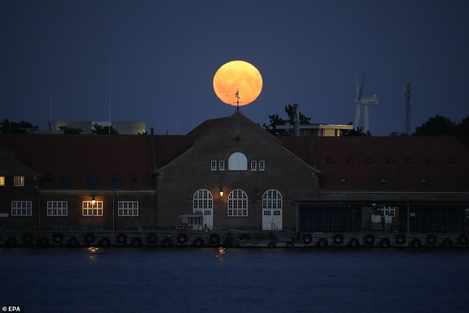 DENMARK: The supermoon over Copenhagen, Denmark. A supermoon occurs when a full moon coincides with the time of year when the moon is closest to the Earth