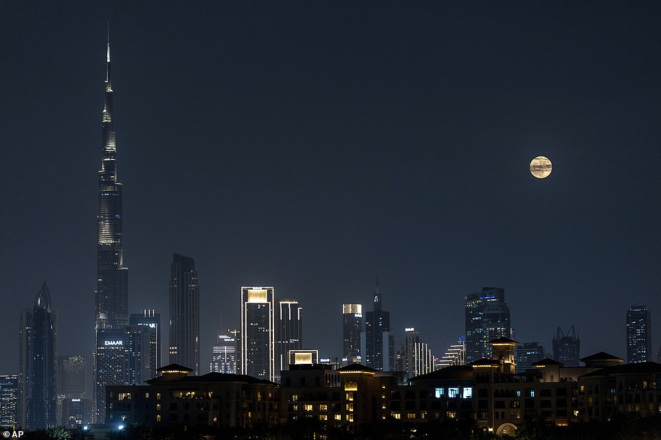 DUBAI: A view of the full moon as it rises over the skyline of the city with the world's tallest tower, Burj Khalifa, in Dubai, United Arab Emirates