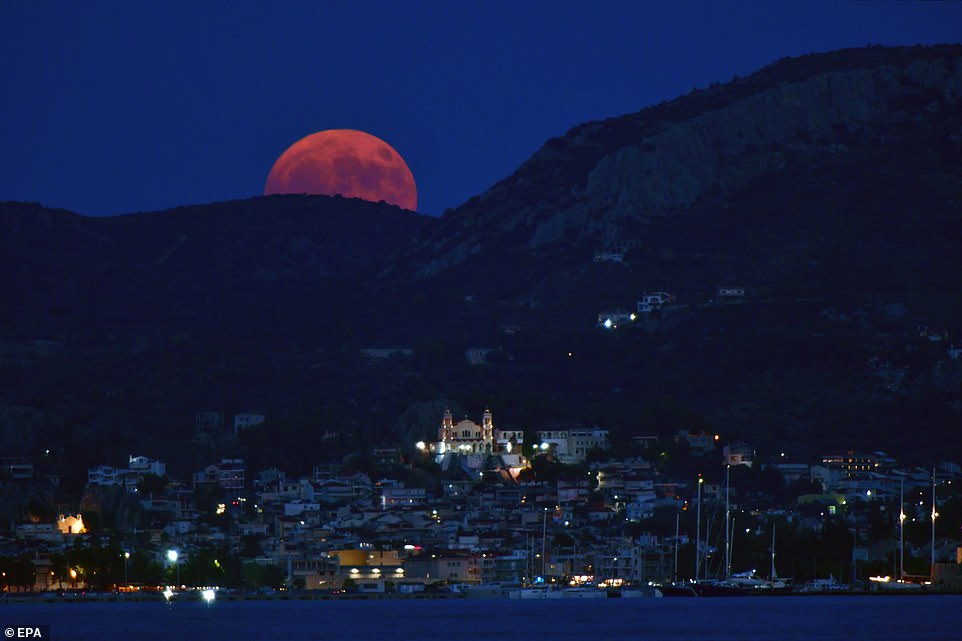 GREECE: The Sturgeon Moon rises over Nafplio, Peloponnese, Greece. The term supermoon was coined in 1979 by astrologer Richard Nolle