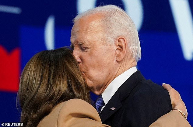 President Joe Biden kisses Democratic presidential nominee and Vice President Kamala Harris after his remarks at the Democratic National Convention Monday night