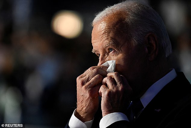 Biden was visibly emotional as he took the stage — and during his speech — last night. He is pictured wiping tears from his eyes