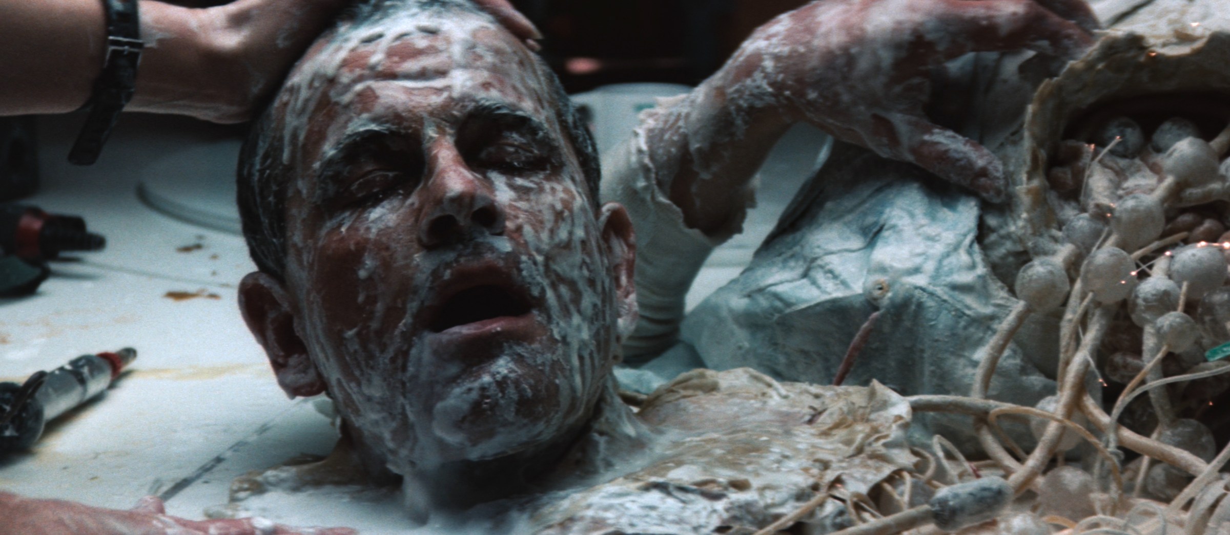 A robot's head is decapitated with white goop on its face in Alien