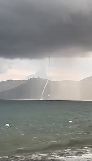 Images from the Gulf of Policastro show a waterspout threatening a motorboat below