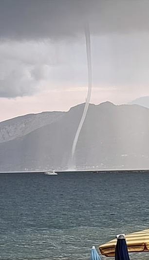 Images from the Gulf of Policastro show a waterspout threatening a motorboat below