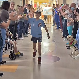 Beau, 10, walked and skipped out of Dell Children's Hospital, high-fiving some of the dozens of people cheering on his recovery