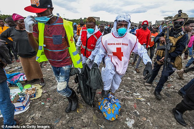 Officials remove bodies found in plastic bags from the landfill on July 13