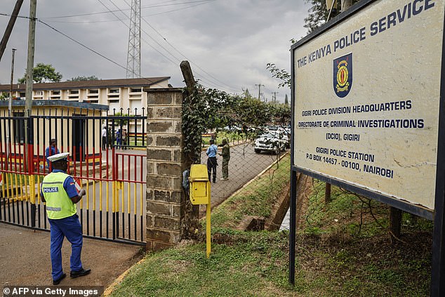 A police officer enters the Gigiri police station after the main suspect in the Kware murder case, Collins Jumaisi, escaped from custody