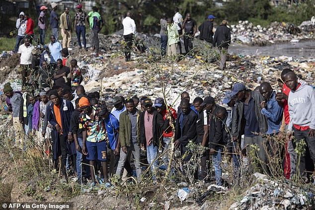 Bystanders gather at the dumpsite where bodies were found at the landfill in Mukuru slum, Nairobi, in July