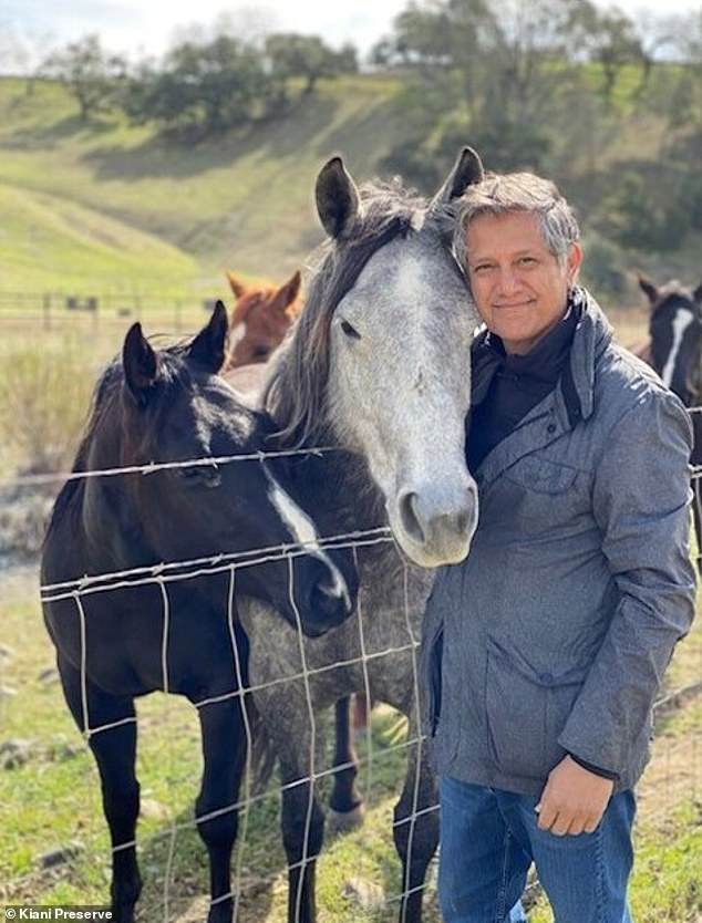 Billionaire Democratic donor Joe Kiani poses with several horses at his Kiani Preserve near Santa Barbara, California. He said he built the estate 