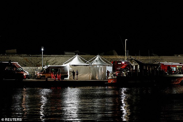 Emergency and rescue workers work at a port near the site where a luxury yacht sank, in Porticello, near the Sicilian city of Palermo, Italy, August 20