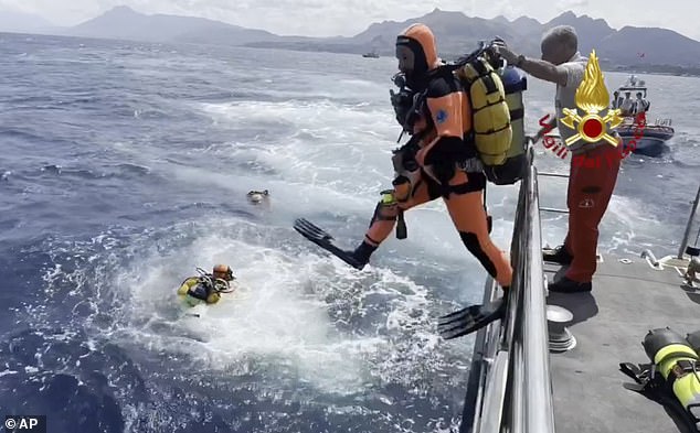 Divers on site during the search for the missing sailboat in Porticello, Italy, today