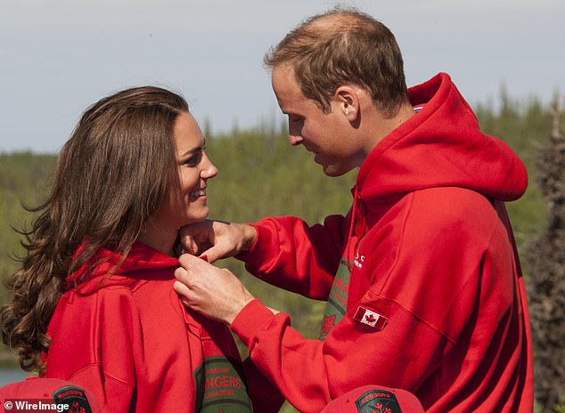 The Prince of Wales fastens Kate's top button during their first official overseas visit since their 2011 wedding