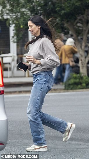 With her cell phone in hand, Erica completed her outfit with a $1,400 pair of honey-colored suede and leather sneakers from Yves Saint Laurent