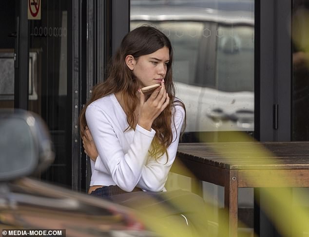 Erica's daughter Indigo (pictured) got into the Byron Bay boho vibe in loose-fitting navy tracksuit bottoms and a white long-sleeved top that reached her waist