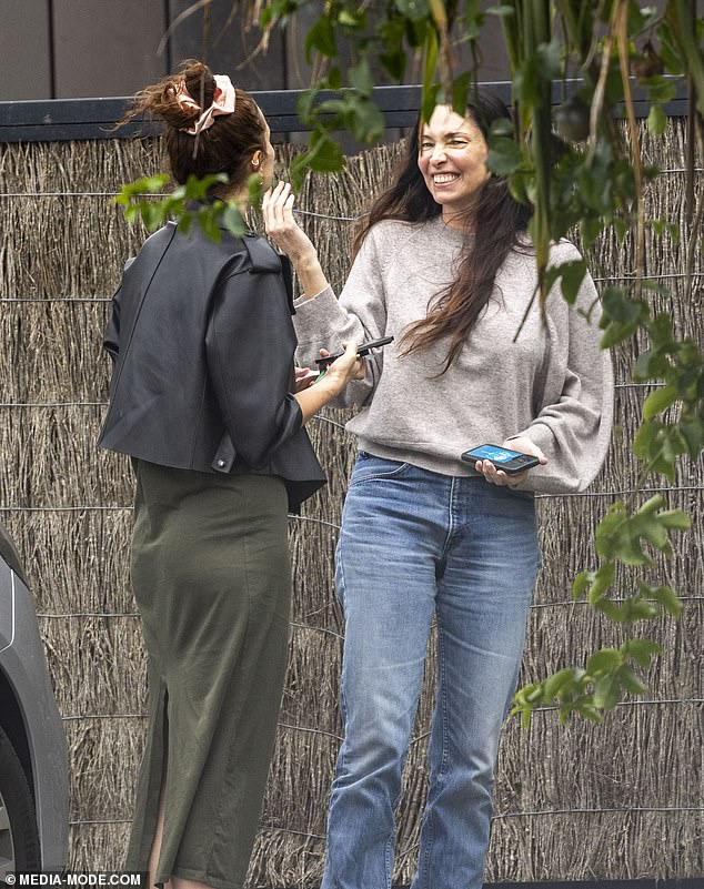 Erica seemed to be having a great time in the coastal village, where she sat chatting with a friend on the street