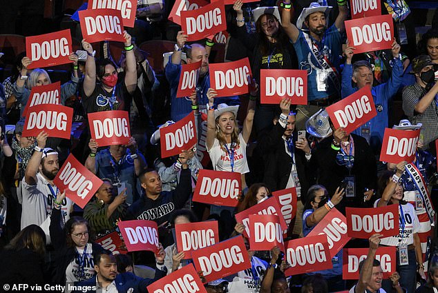 Delegates and attendees hold up 'Doug' signs during his speech at the convention