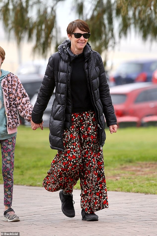 Tasma wore a dark puffer jacket over a black knitted sweater which she paired with red floral pants and black running shoes